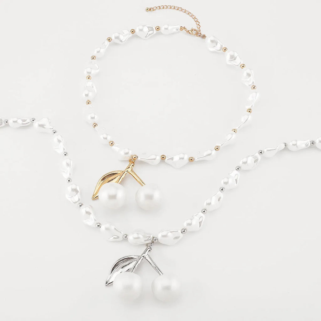 Women's creative necklace with gold alloy cherry fruit pendant on a white imitation pearl chain.