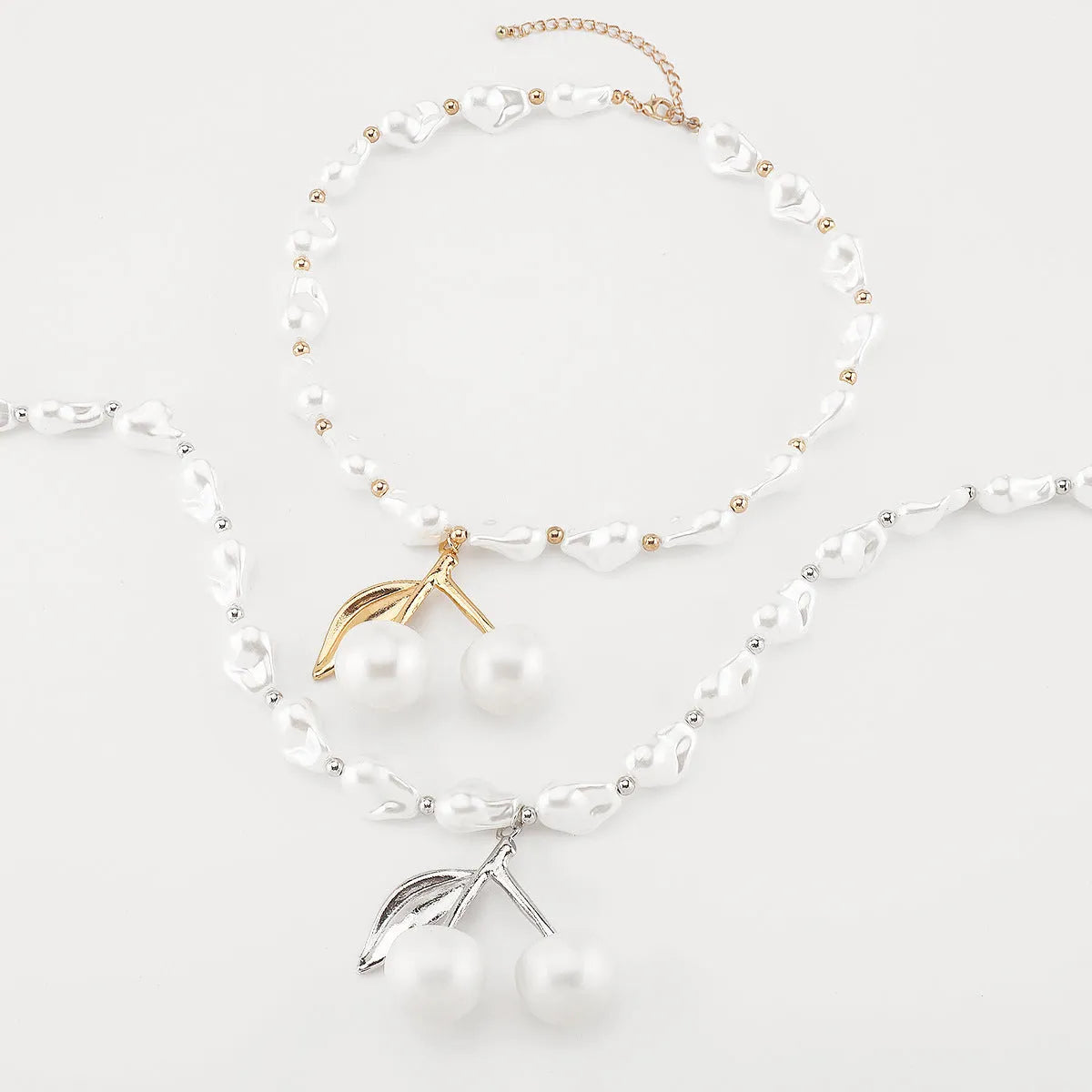 Women's creative necklace with gold alloy cherry fruit pendant on a white imitation pearl chain.