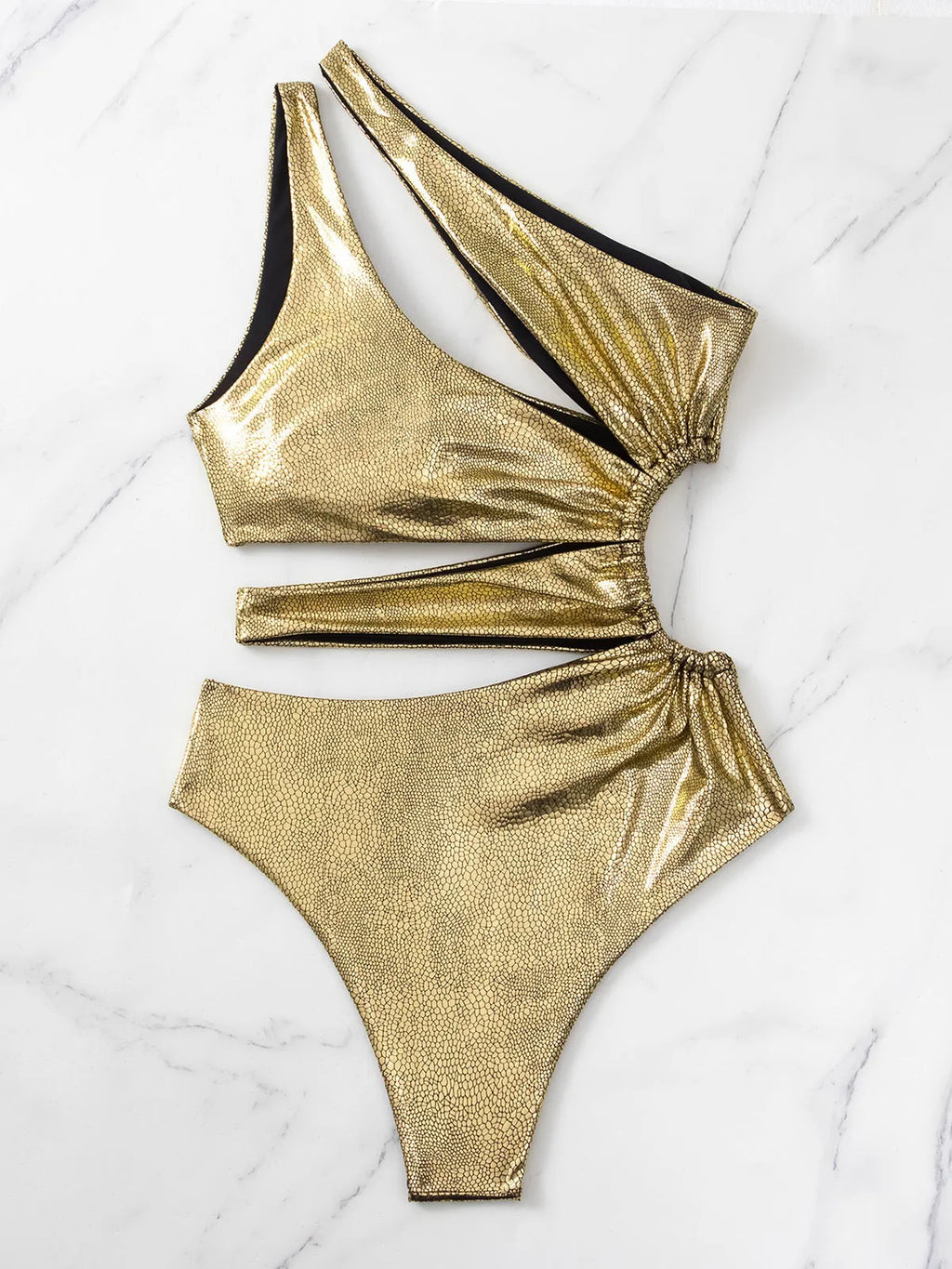 Gold coloured backless one-piece swimsuit for women on a hanger.