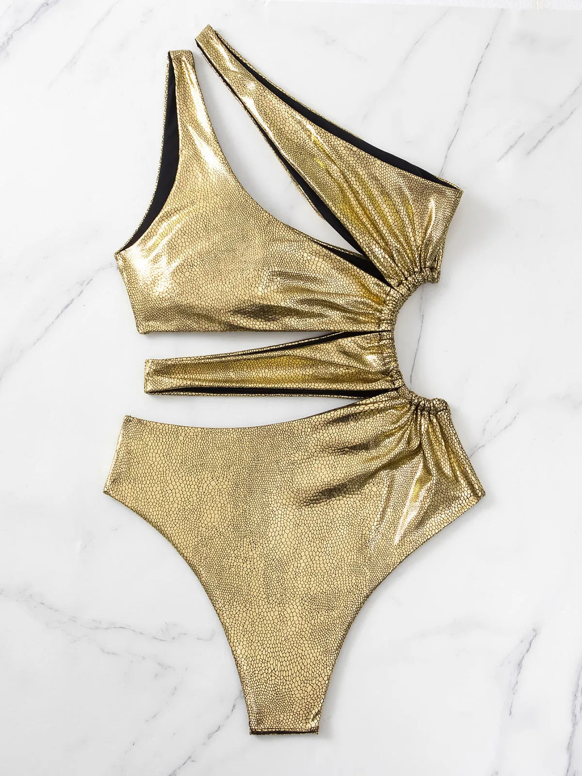 Gold coloured backless one-piece swimsuit for women on a hanger.