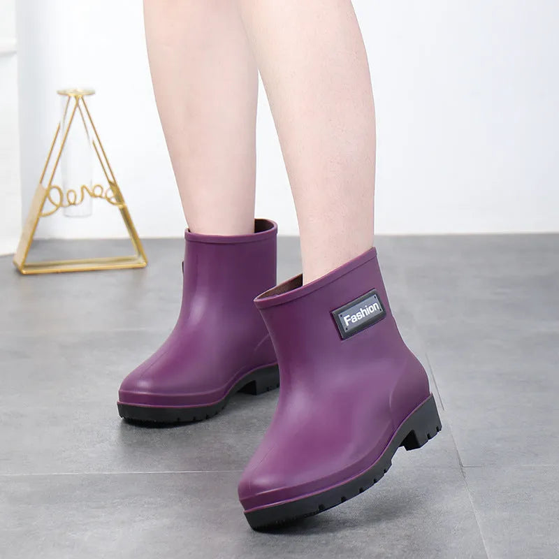 Women's mid-calf PVC rain boots in black, shown with a low heel and optional warm lining.