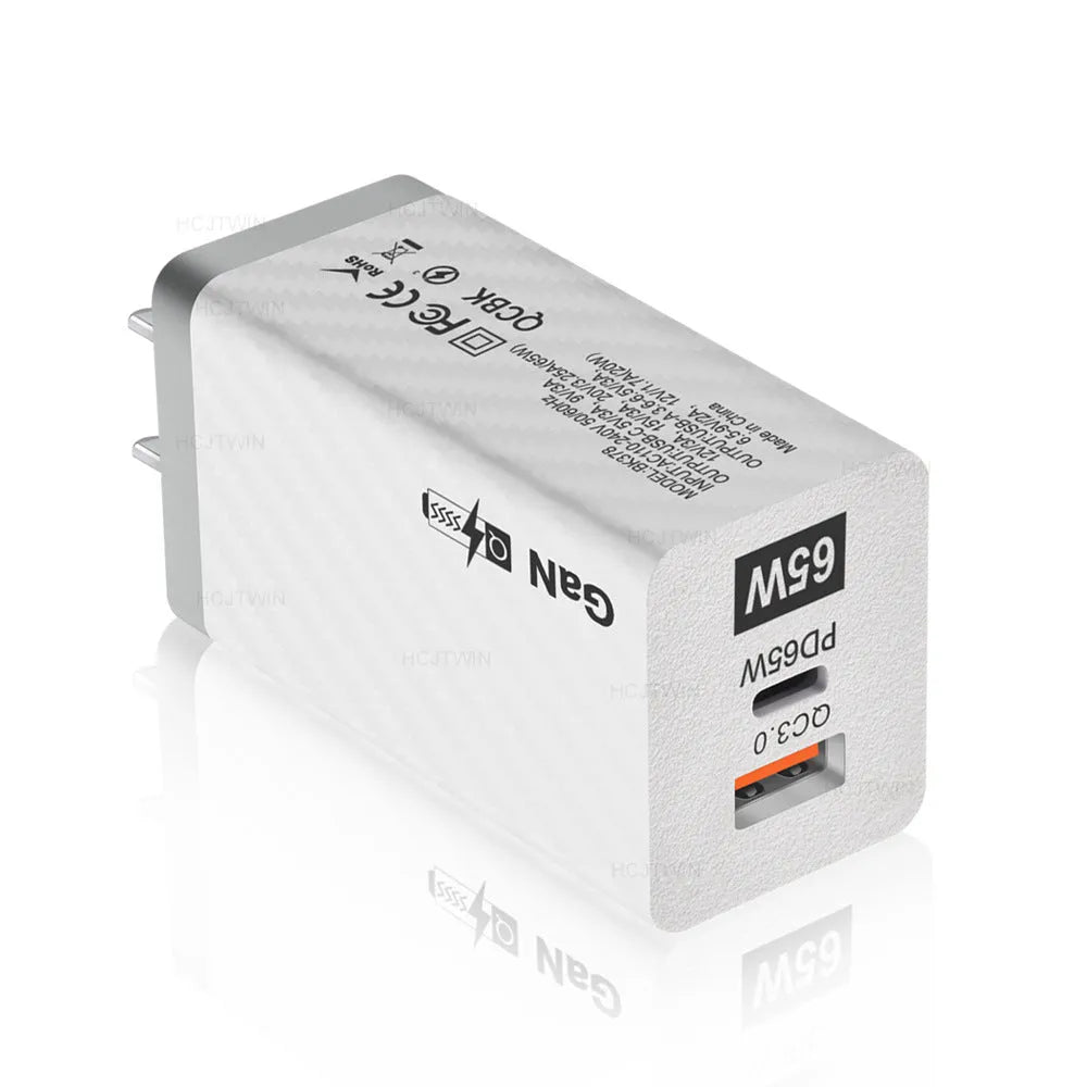 65W GaN universal laptop charger with UK, US, and EU plug heads in black or white