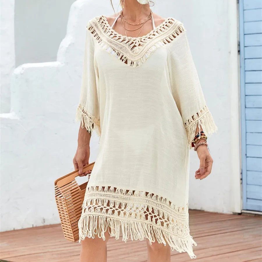 Apricot women's crocheted patchwork beach dress with half sleeves on a hanger.
