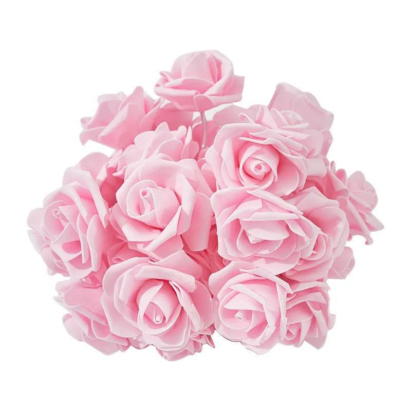 Battery-powered LED fairy lights with ten pink PV foam roses on a 1.5-metre wire for indoor decoration.
