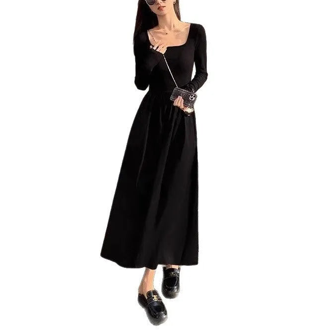 Women's black knitted square collar A-line dress with long sleeves and an elastic waist.