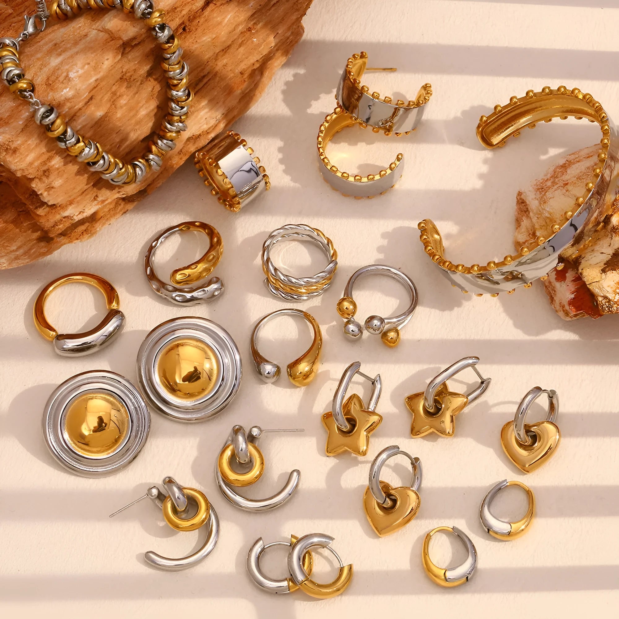 Gold geometric stainless steel jewellery set for women, including earrings, bracelet, and necklace.
