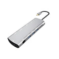 Grey aluminium USB-C docking station showing HDMI, VGA, USB, and charging ports.