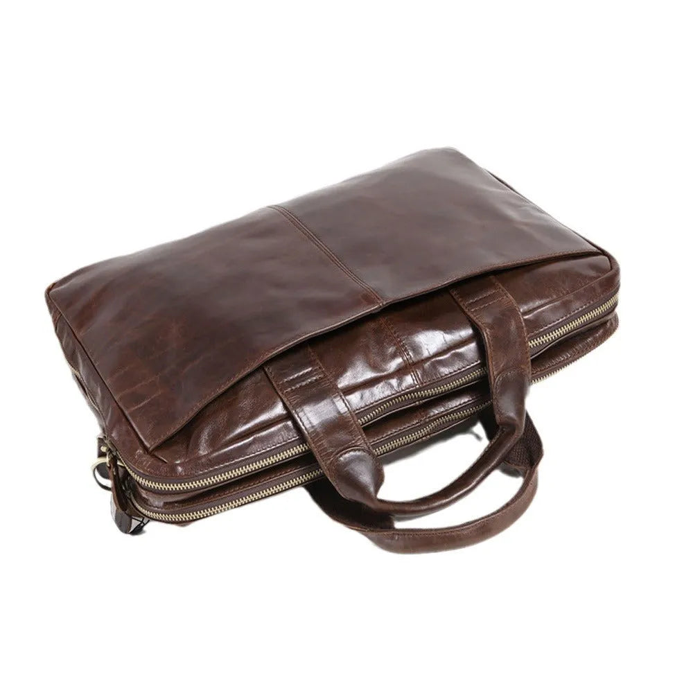 Brown leather business briefcase with visible cowhide pattern, measuring 18 inches with internal polyester cotton lining