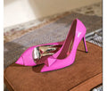 Pink women's pointed toe stiletto high heels with buckle detail on patent leather upper.