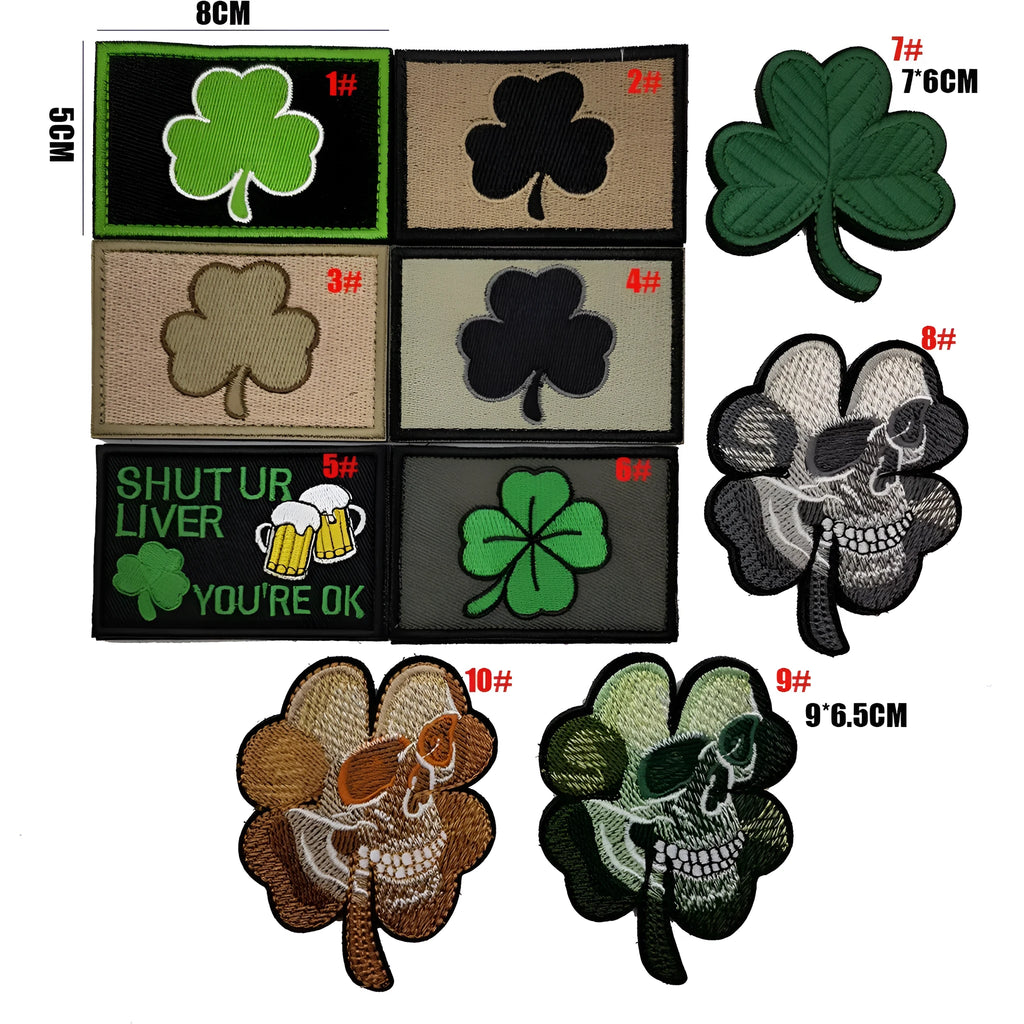 Embroidered fabric badge with Velcro strip backing on a green clover design