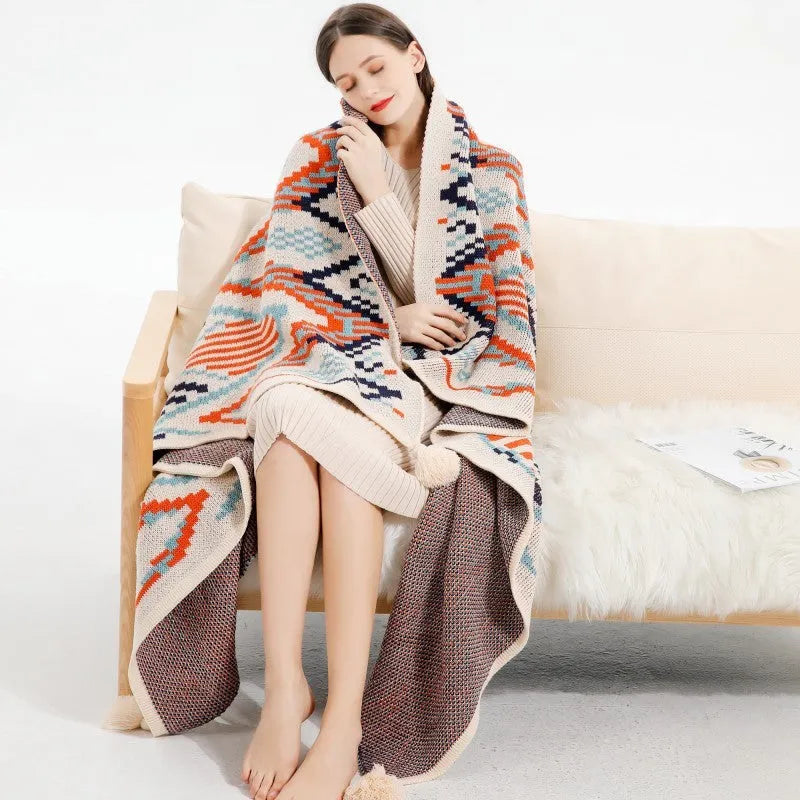 Bohemian style acrylic sofa cover blanket with tassel trim in a geometric pattern colour option.