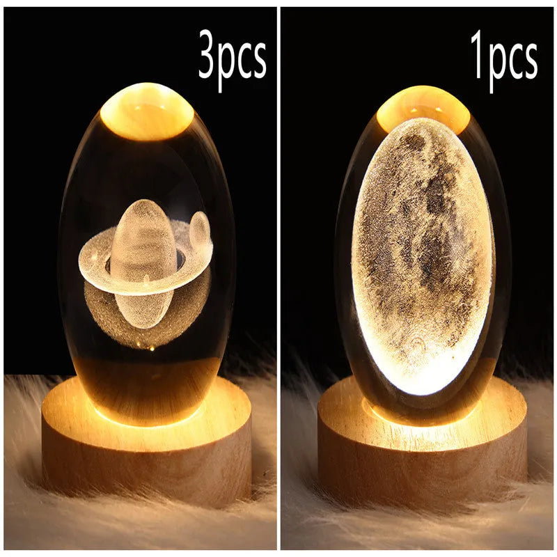 LED galaxy crystal ball night light with 3D planet designs on a table