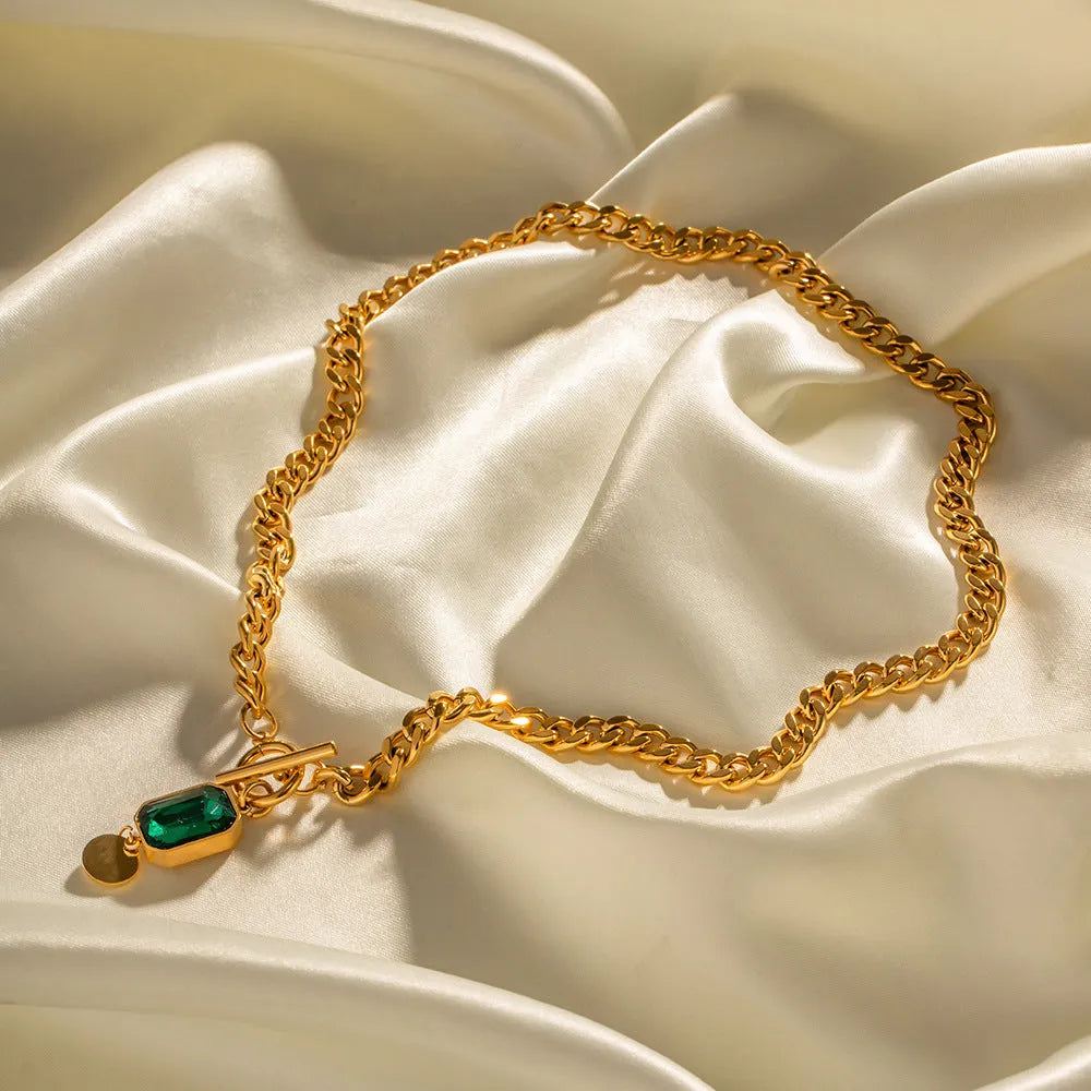 Gold French retro necklace with round geometric pendant featuring emerald zircon stone on Cuban link chain