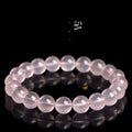Women's pink polished crystal round bead bracelet in natural starlight style on a white background.