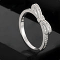 Silver bow-shaped ring with zircon rhinestone crystals on electroplated band