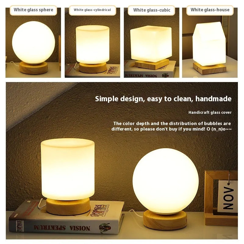 White Nordic solid wood USB table lamp with touch dimming in cube shape on a wooden table.