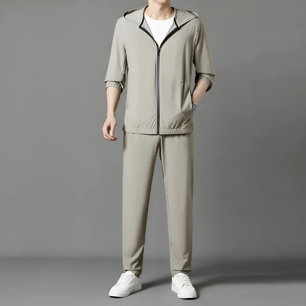 Grey hooded sun-protective top and trousers casual set laid flat showing loose fit and pocket detail