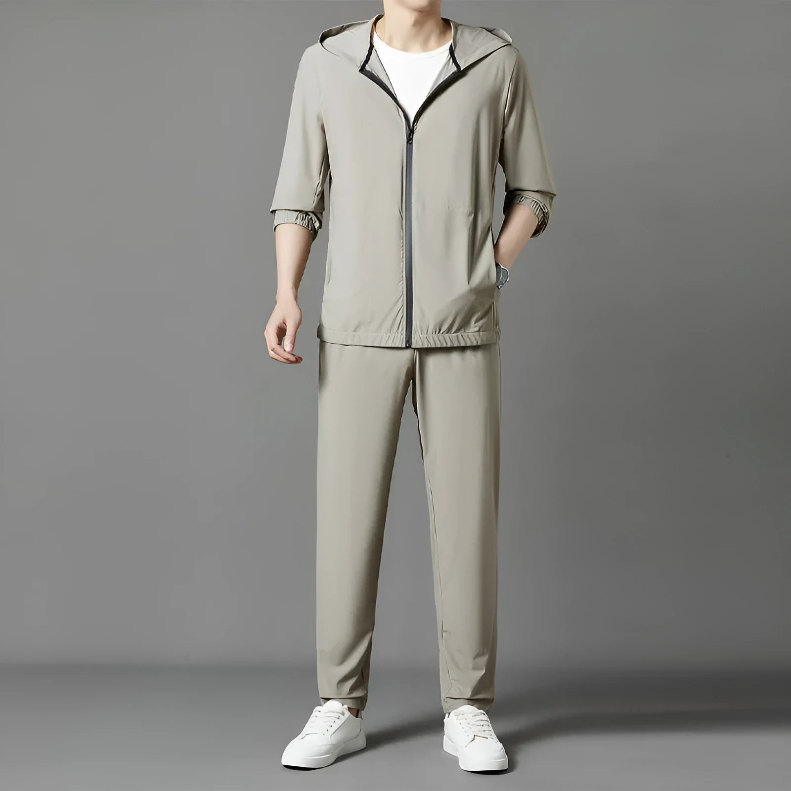 Grey hooded sun-protective top and trousers casual set laid flat showing loose fit and pocket detail
