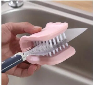 Blue U-shaped plastic brush with bristles for cleaning knives and cutlery in a kitchen.