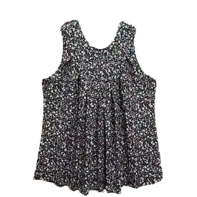 Plus size woman wearing a black floral print sleeveless loose-fit vest top.