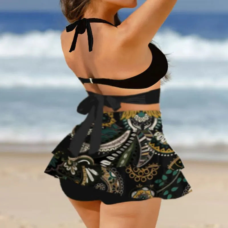 Black high-waist women's bikini with lace-up back and matching swim skirt laid flat.