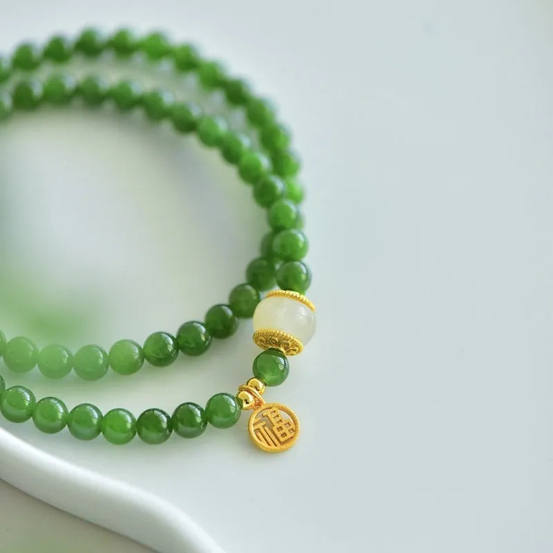 Women's double circle bracelet made from natural Hetian jade with 6mm geometric beads and a fu charm.