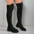 Black lace-up over-the-knee boots with a round head and flat rubber sole on a neutral background.