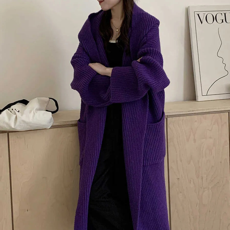 Women's milky white loose hooded cardigan coat with long raglan sleeves on a hanger.