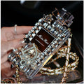 iPhone perfume bottle bow phone case in black with matte TPU shell and gold metal chain holding a perfume bottle charm.