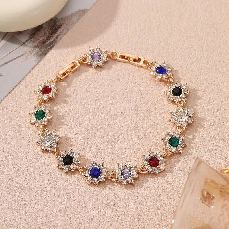 Coloured gemstone bracelet with flower-shaped design in gold and silver colour variations