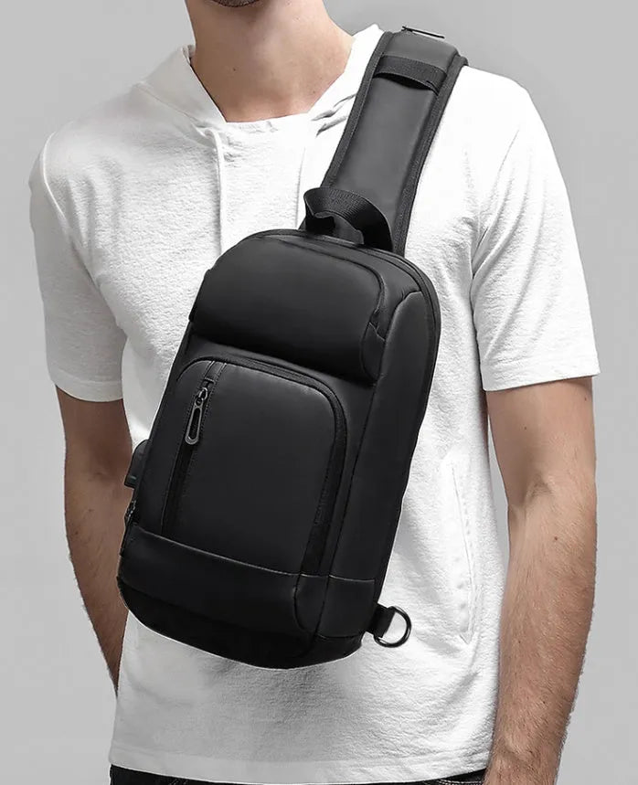 Black medium outdoor shoulder bag with air cushion strap showing internal laptop and organiser pockets