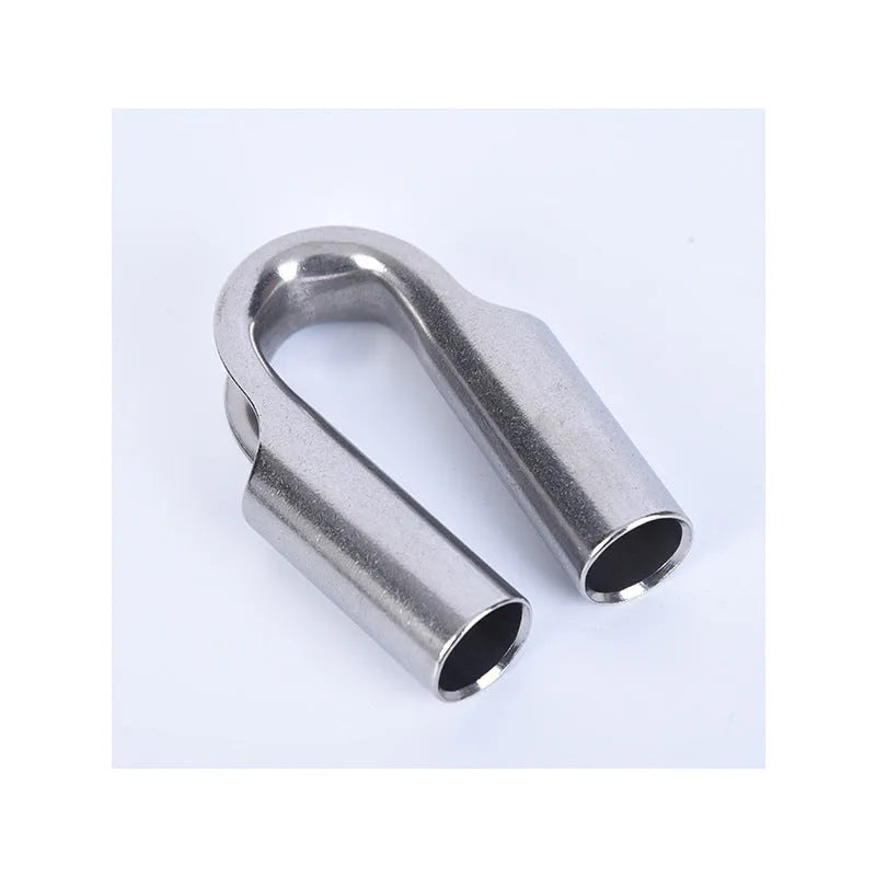 Stainless steel tubular chicken heart shaped sleeve ring set showing various metric sizes on a workbench.