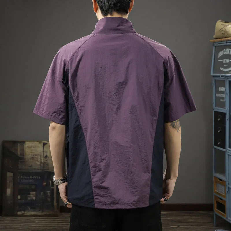 Man modelling a brown half-zip stand collar casual shirt with short sleeves.
