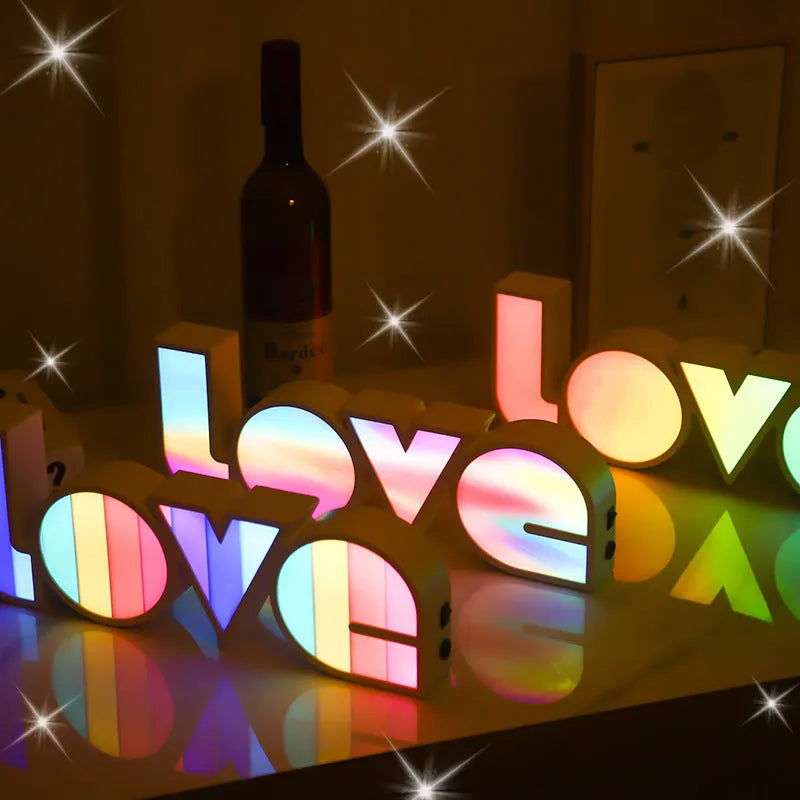 Rainbow halo style LED LOVE decorative light measuring 35.5cm wide
