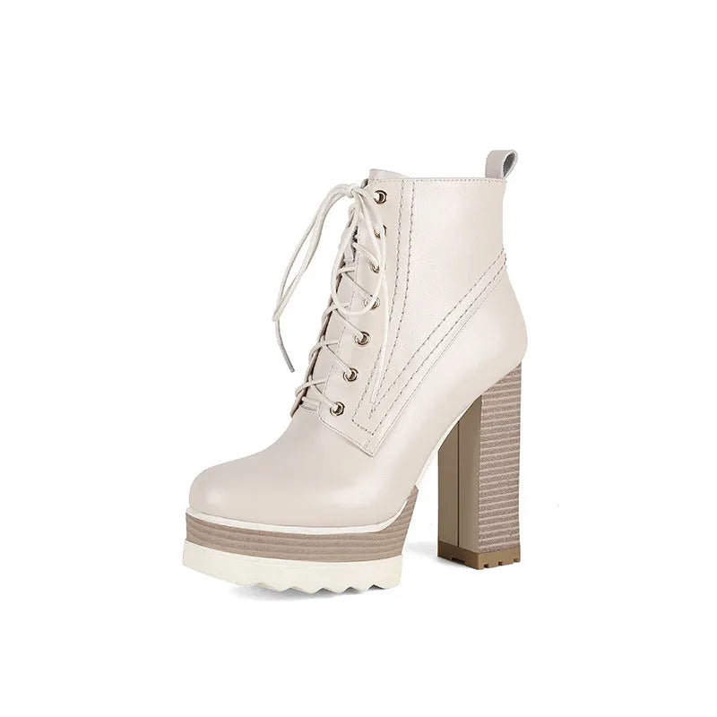 Women's black chunky heel waterproof ankle boots with a side zip on a white background.
