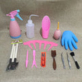 A succulent gardening tool set showing a mini watering can, bucket, tweezers, drip kettle, shovel, rake, and brush on a table.
