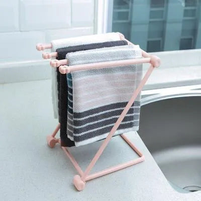 Light grey foldable plastic dishcloth shelf on a kitchen countertop