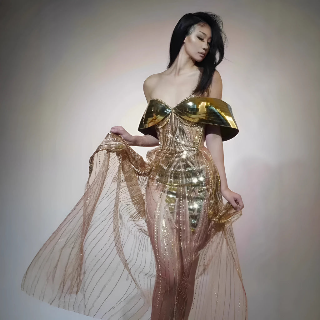 Gold strapless sequined formal dress with a side split on a long tulle skirt.