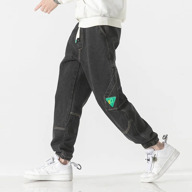 Men's loose-fit tapered cotton trousers in black, blue, and grey colours with mid waist design