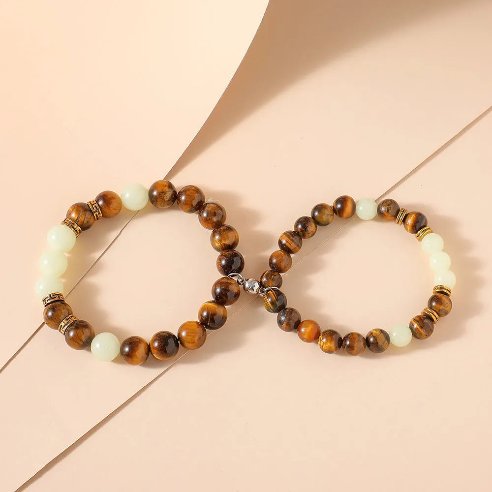 Geometric amber couple bracelets with luminous retro styling on display