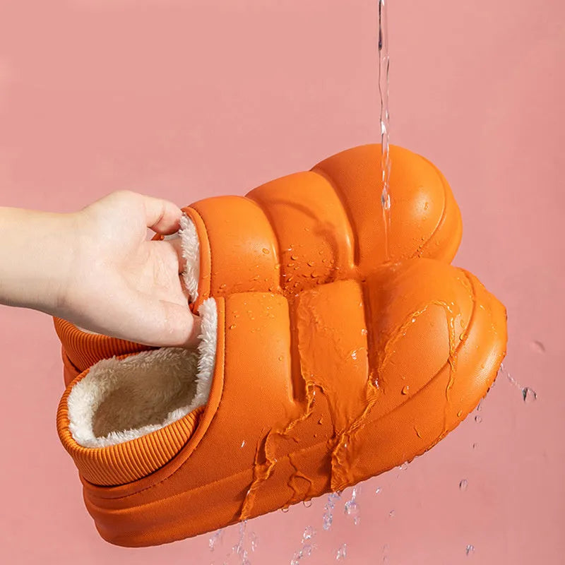 Women's waterproof EVA slippers in various colours with plush lining and a non-slip flat sole.
