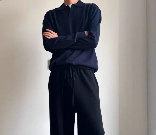 Man wearing a milky white pure wool polo sweater with a lapel collar, showcasing its loose fit.