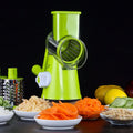 Blue green mandoline vegetable slicer with suction cup base and three stainless steel blades.