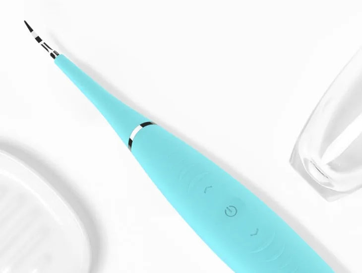 Pink and blue waterproof electric dental calculus remover tool on a white background