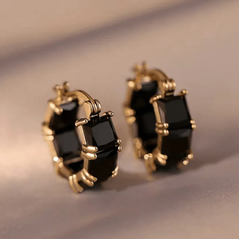 Geometric U-shaped gold earrings with black crystal zirconium stones in round design