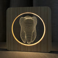 Wood colour tooth-shaped acrylic USB night lamp on a surface
