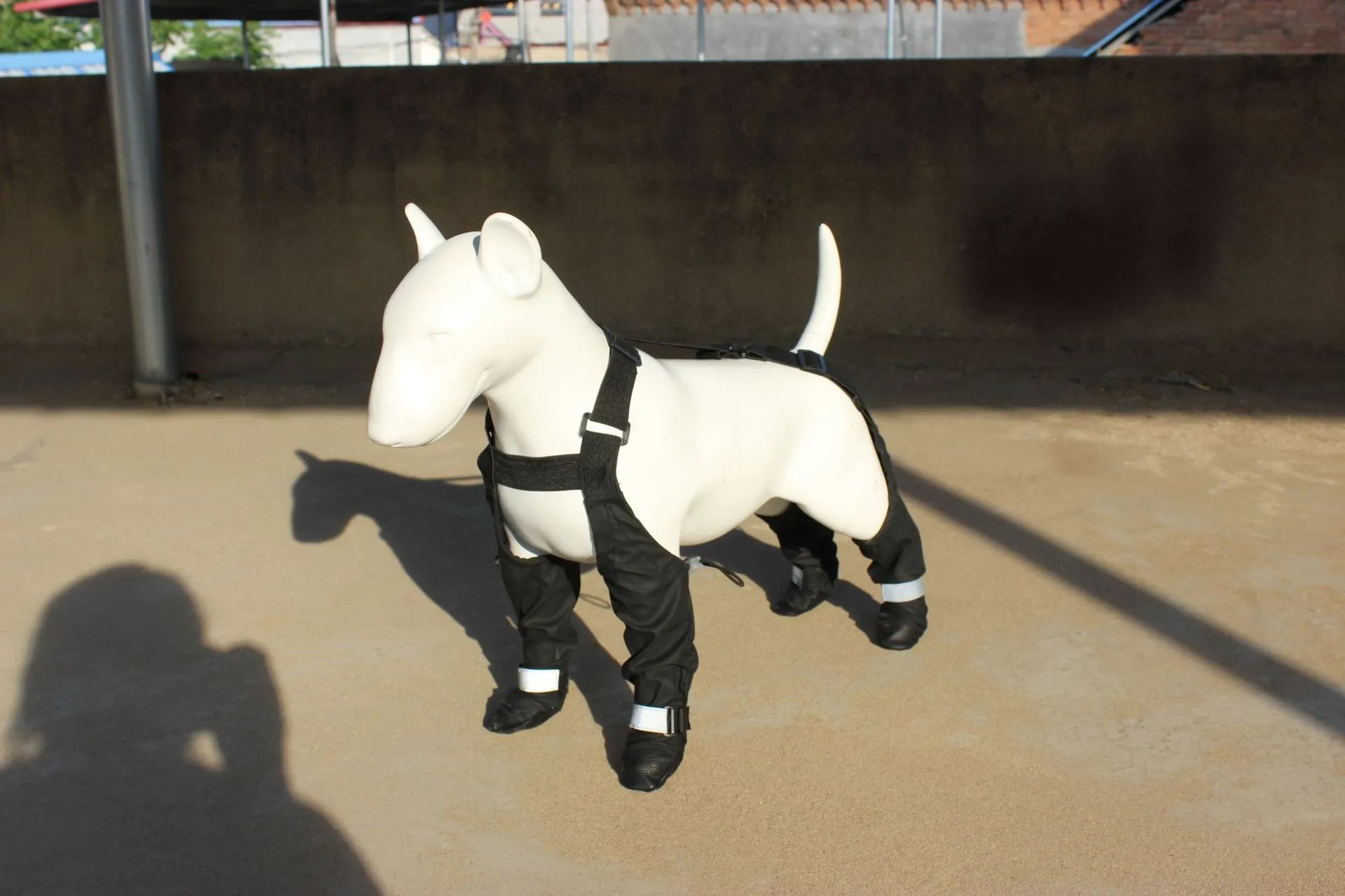 Black dog shoes with adjustable strap closure showing waterproof non-slip sole design