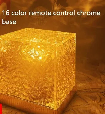 LED water ripple night light with rotating crystal projection and remote control on wooden surface
