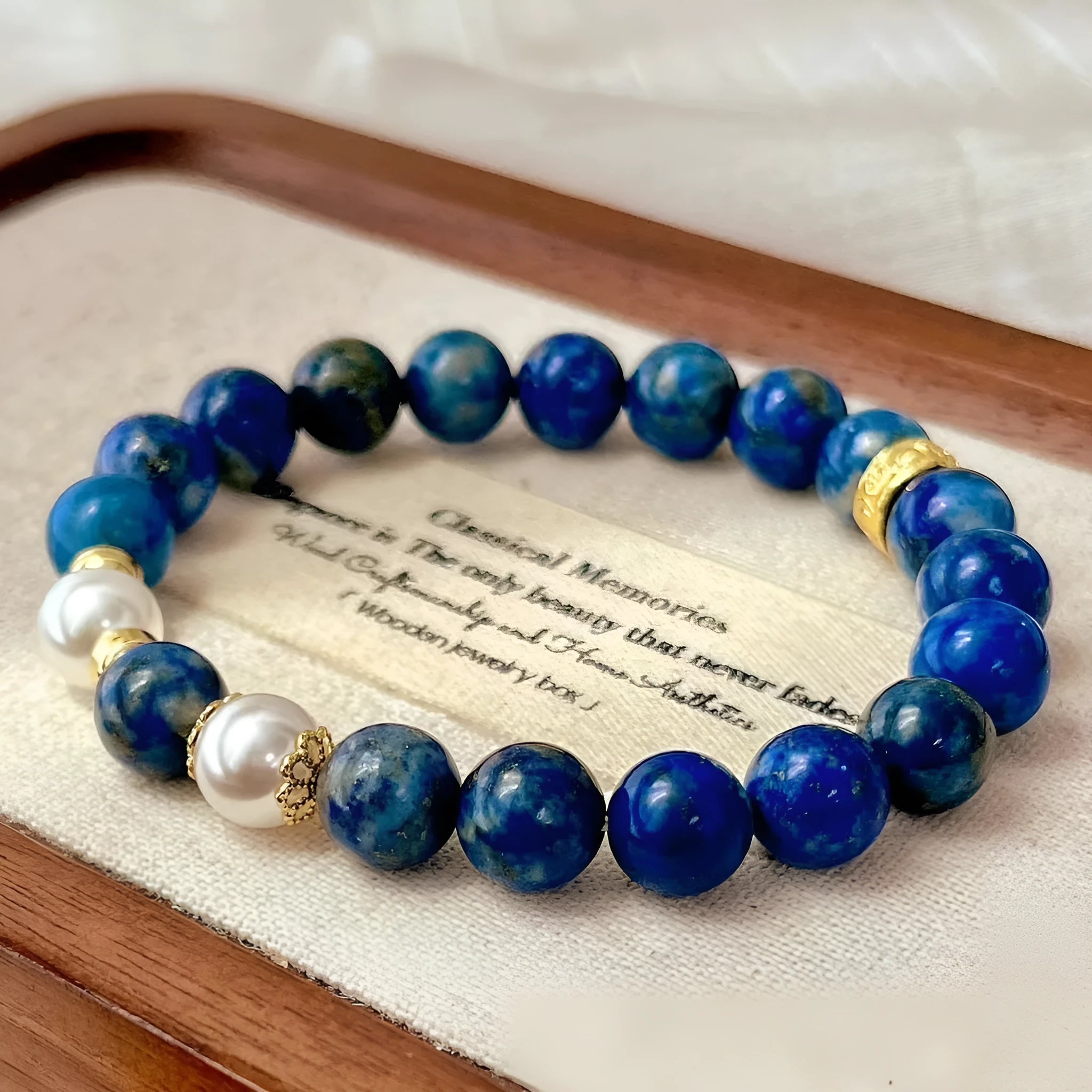 Chinese-style artistic retro lapis lazuli bracelet with green and gold stone on a white background.