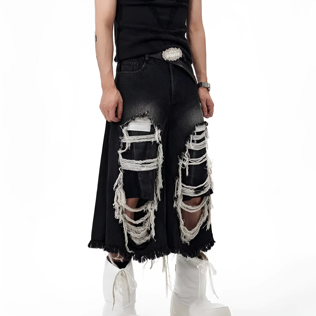 Model wearing black cropped wide-leg jeans with a distressed patch detail on the leg.